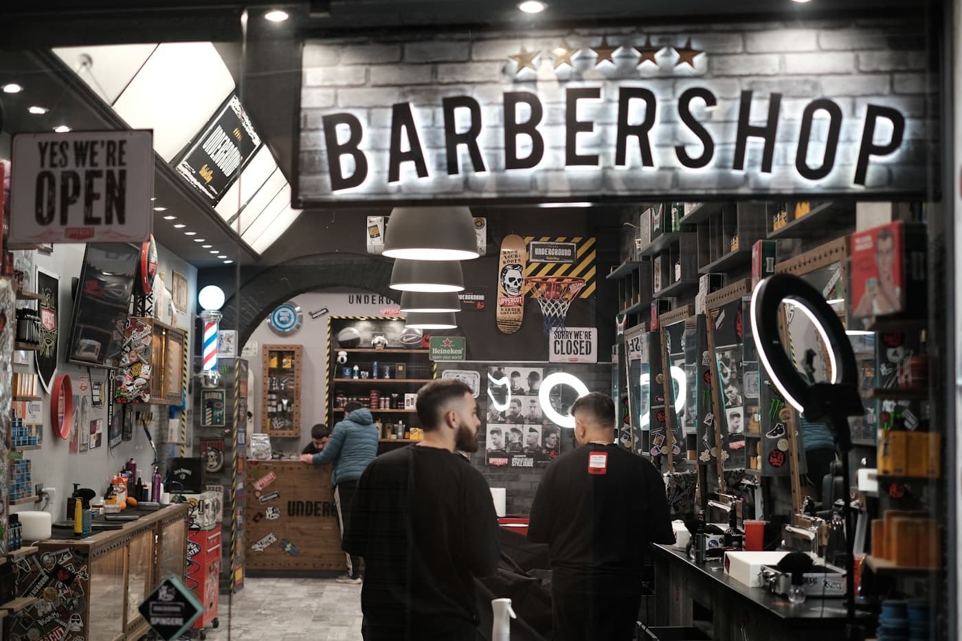 Barbershop storefront with the lights on